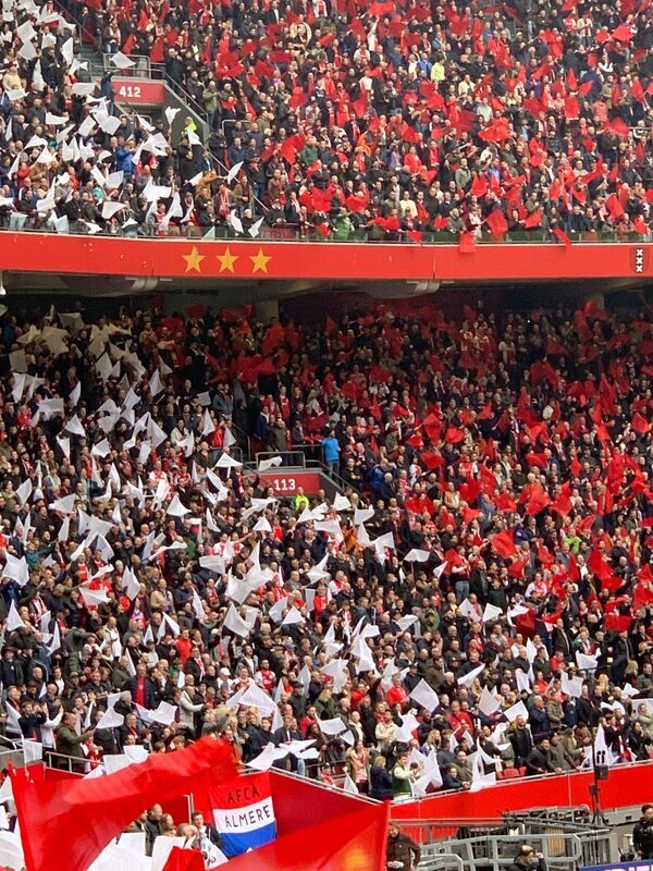 Packed stands with red and white flags in the Johan Cruijff ArenA